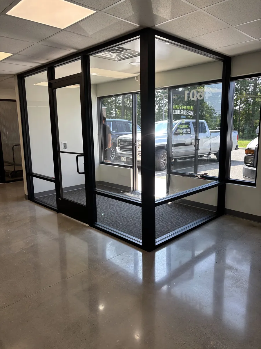 A black-framed glass entry vestibule just inside an office's front windows